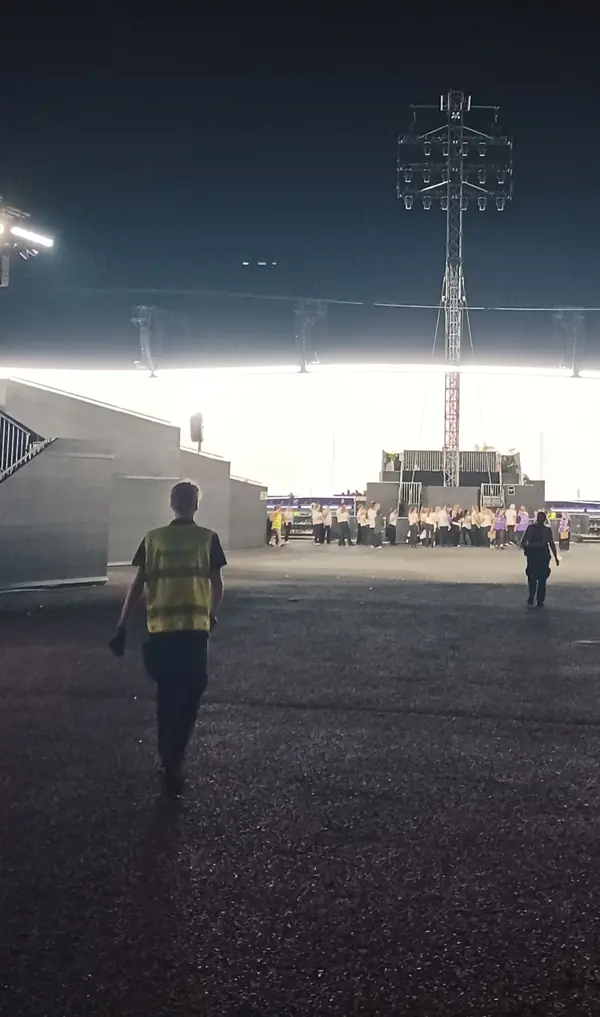 Staff closing access after Adele’s Munich show, seen from behind, August 9, 2024 (cropped; not the Las Vegas security staff)