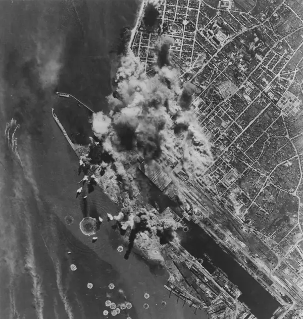 “Raid over St. Nazaire, France”: bombs bursting on the port, 1942–43 (another raid, not Magee’s)