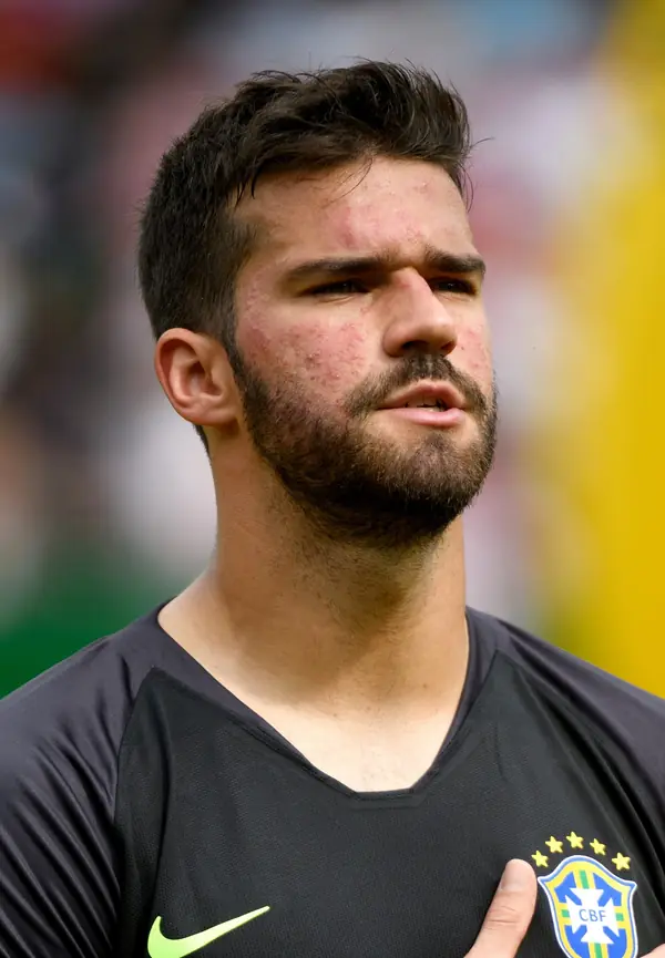 Alisson Becker, hand on chest, looking up, at Austria v Brazil, Vienna, June 10, 2018 (not the 2021 match)