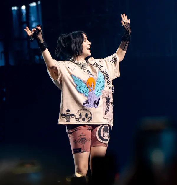 Billie Eilish on stage with her arms raised, The O2, London, June 16, 2022 (not the 2020 Grammys)