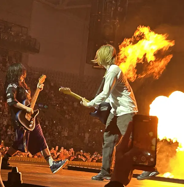 Billie Eilish and Finneas playing guitars beside stage flames, Oslo, April 26, 2025 (not the 2020 Grammys)