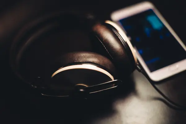 Headphones and a smartphone on a table, a stock photo, January 24, 2017 (a stand-in)