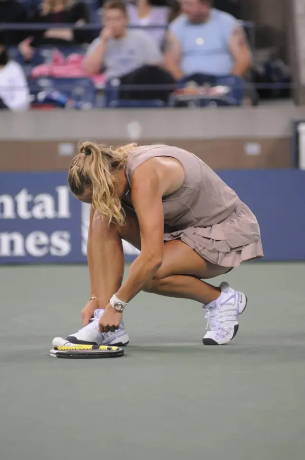 Caroline Wozniacki crouched on court, tying a shoe, at the US Open, September 7, 2009 (not the collapse in Doha)