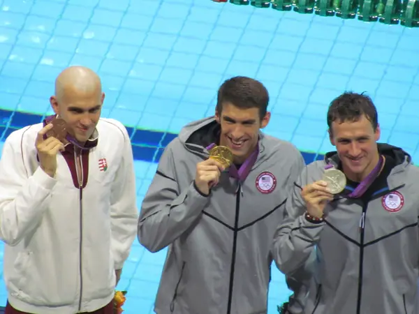 Michael Phelps (center) with László Cseh (left), Ryan Lochte (right) and their 200-meter individual medley medals, London, August 2, 2012 (not the butterfly)