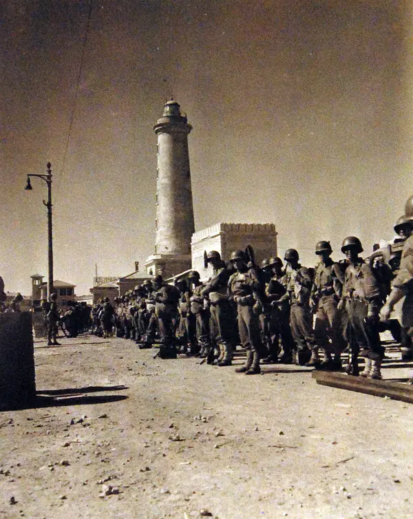 Allied troops by the lighthouse at Licata, Sicily, 1943
