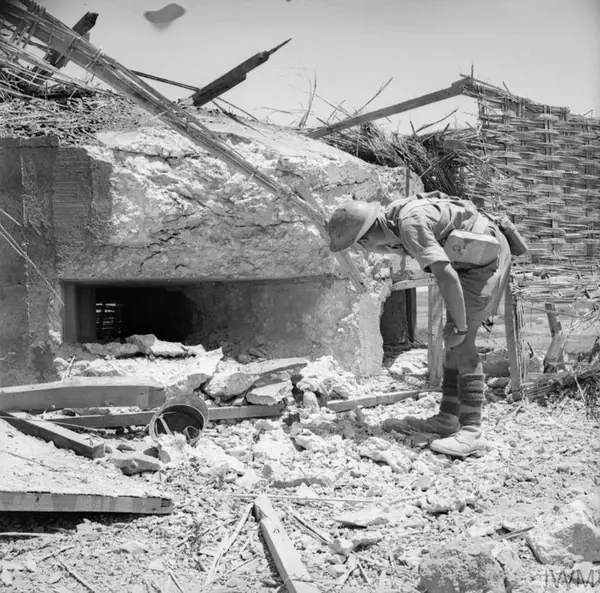 A British soldier inspects a captured Italian pillbox near Pachino, Sicily, July 1943 (not the one Chips charged)