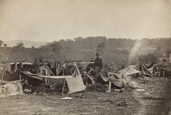 Dr. A. Hurd, 14th Indiana Volunteers, attending to Confederate wounded after the Battle of Antietam, photo by Alexander Gardner, 1862 (not where Barton worked)