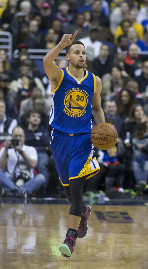Stephen Curry pointing up as he brings the ball up against the Wizards, Washington, February 3, 2016 (not a Finals game)