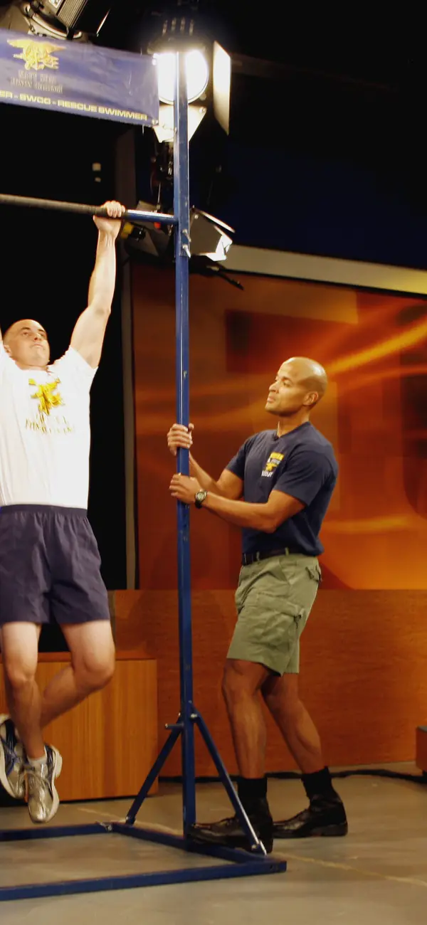 David Goggins coaching a prospective sailor through pull-ups at a Navy fitness event, Seattle, July 7, 2009 (cropped; not his record)