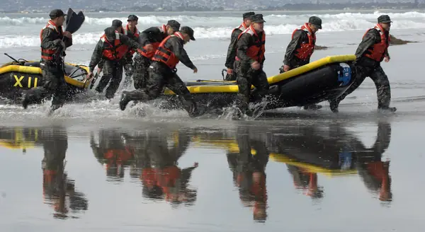 BUD/S students rush their boats to the finish of a surf passage in Hell Week, Coronado, January 29, 2007 (not Goggins)