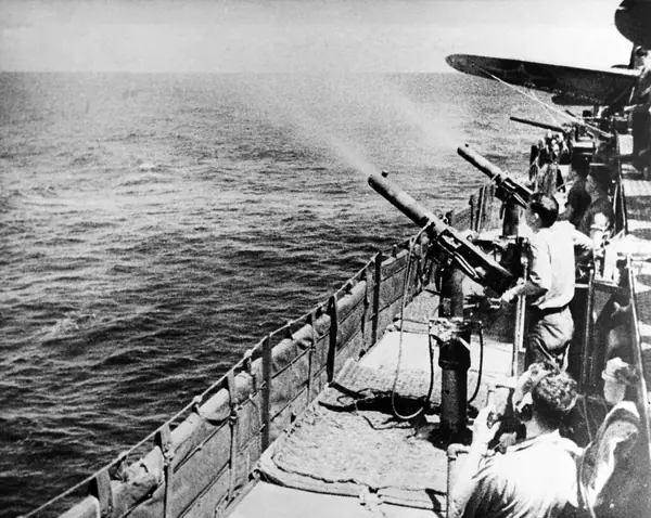 Machine guns aboard USS Enterprise (CV-6) firing at Japanese aircraft, 1 February 1942 (NH 50935)