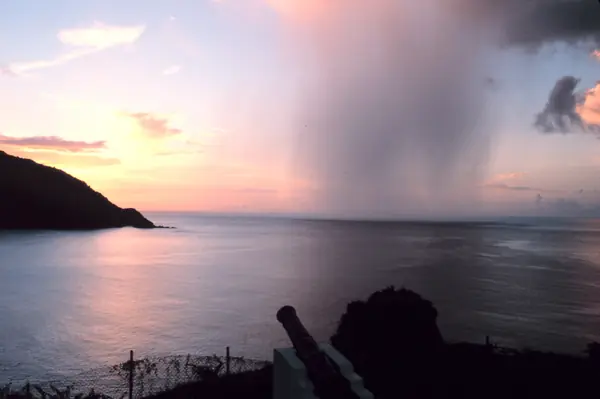 A rain shaft at sunset over Man-of-War Bay, Tobago, 1980 (not the storm that reached the rafts)