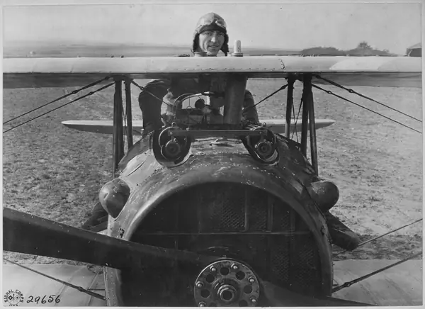 1st Lt. Eddie Rickenbacker of the 94th Aero Squadron standing up in his SPAD, France, October 18, 1918
