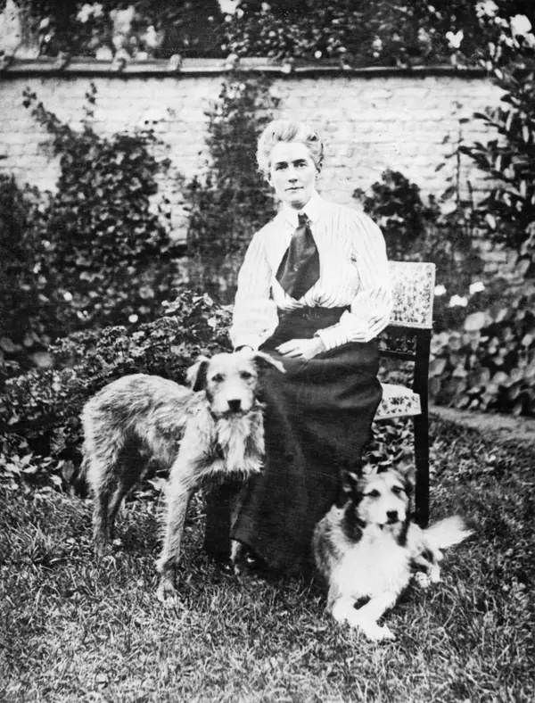 Edith Cavell with her two dogs in her garden in Brussels, before the war