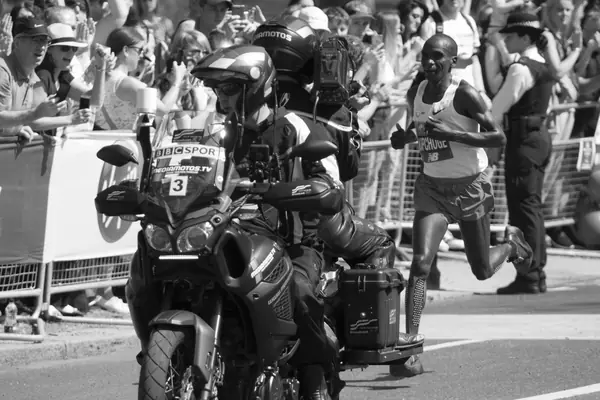 Eliud Kipchoge beside a camera motorbike at the London Marathon, April 22, 2018 (not Monza or Vienna)
