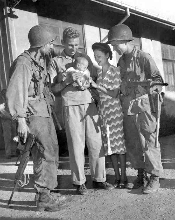 Hal Bowie, his wife and their baby, Lea, with two 11th Airborne paratroopers after the Los Baños raid, February 23, 1945 (fellow internees, not Buckles)