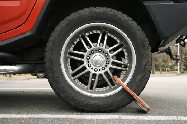 The wheel boot on the same car, seen from farther back, Durham, North Carolina, February 26, 2009 (not the mother’s car)