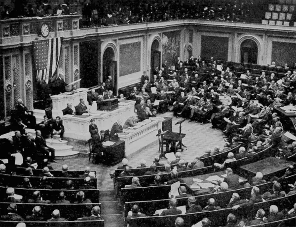 The US House of Representatives in session, 1921 (his hearing was in a committee room)