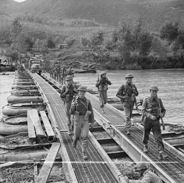 Troops cross a pontoon bridge over the Volturno, Italy, October 15, 1943