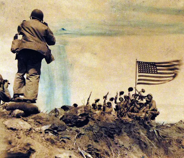 Marines cheering under the second flag, February 23, 1945, photographed by Pfc. Bob Campbell, USMC; the AP photographer Joe Rosenthal is in the left foreground