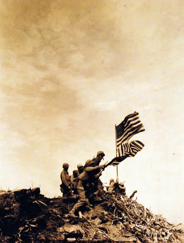 Marines putting up the second, larger flag on Mount Suribachi, February 23, 1945, photographed by Pfc. Bob Campbell, USMC