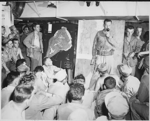 Lieutenant Wade discusses overall importance of target at pre-invasion briefing. Invasion of Iwo Jima, circa February... - NARA - 532364