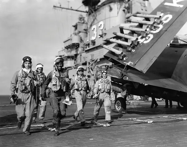 Jesse Brown (center) walks across the flight deck of USS Leyte with fellow pilots, November 1950