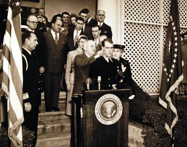 Truman places the Medal of Honor around Hudner’s neck, White House, April 13, 1951