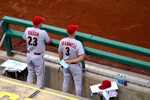 Kirk Gibson (No. 23) and Alan Trammell in Arizona’s dugout, seen from behind, July 1, 2014