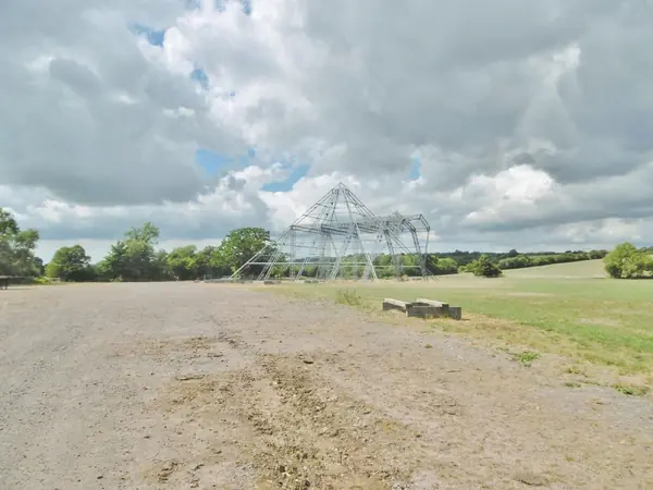 The bare Pyramid Stage frame on an empty field at Worthy Farm, July 31, 2018, between festivals (not 2023 or 2025)