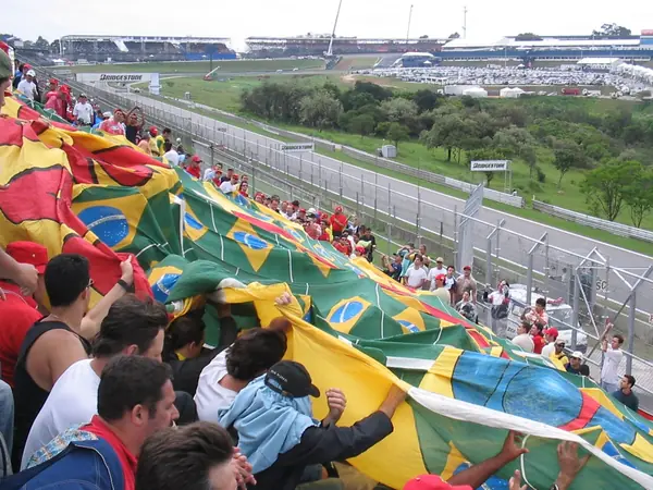 Fans with a giant Brazilian-flag banner at the Brazilian Grand Prix, Interlagos, October 2004 (rotated and cropped)