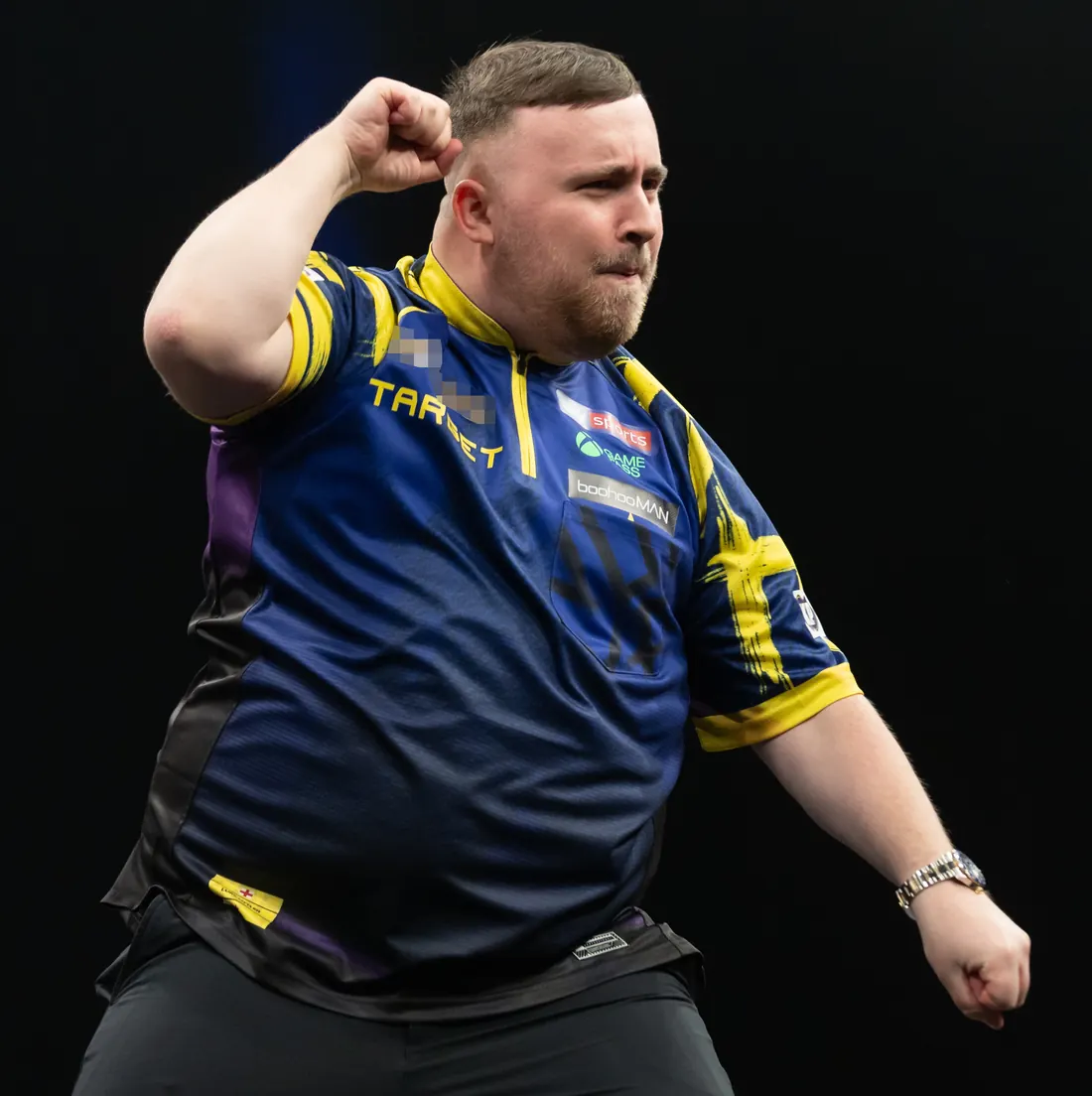 Luke Littler celebrating during his match with Michael van Gerwen at a Premier League Darts night, Berlin, March 26, 2026 (cropped; logo pixelated; not the world final)
