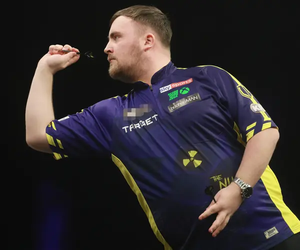 Luke Littler throwing at a Premier League Darts night, Berlin, April 3, 2025 (cropped; logo pixelated; not a World Championship)