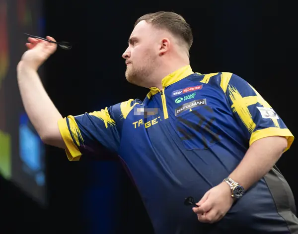 Luke Littler throwing at a Premier League Darts night, Berlin, March 26, 2026 (cropped; logo pixelated; not a World Championship)