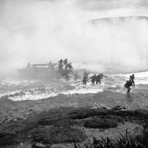 Commandos come ashore under a smoke screen in training at Inveraray, Scotland, October 9, 1941; Jack Churchill, with his sword, is at far right