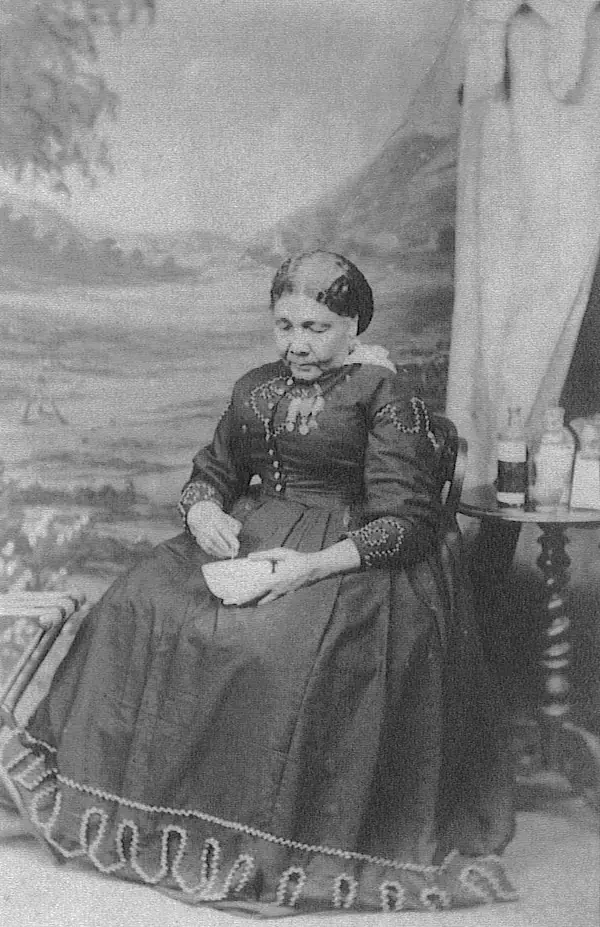 Mary Seacole seated beside a tent and medicine bottles, Maull & Co., London, about 1873