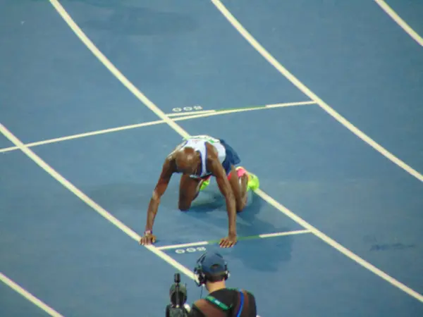 Mo Farah on his hands and knees on the track after the finish, Rio de Janeiro, August 13, 2016