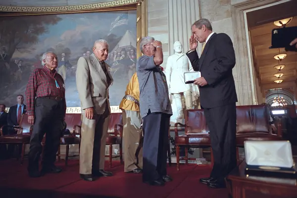 President George W. Bush salutes the Navajo code talkers at the US Capitol, July 26, 2001
