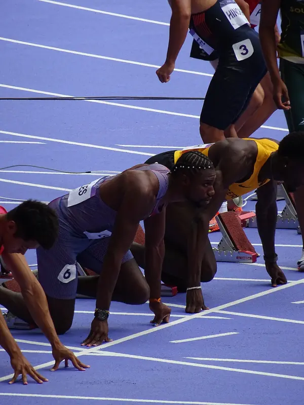 Noah Lyles settling into his blocks in the men’s 100 m first round, Stade de France, Paris, August 3, 2024 (not the final)