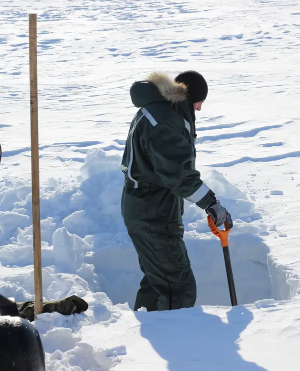 A hydrologist digging a snow pit on the Aldegonda glacier, Svalbard, May 1, 2023 (cropped; not the BBC crew)