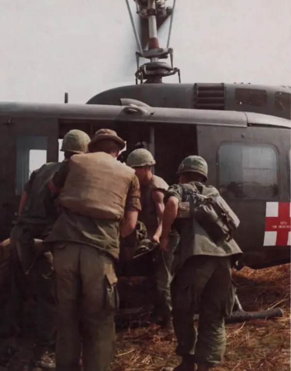 A wounded soldier is loaded onto a 57th Medical Detachment UH-1D medevac
