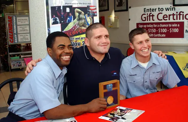 Rulon Gardner with his Olympic gold medal and two U.S. Navy dental technicians, Naval Air Facility Atsugi, Japan, November 27, 2002