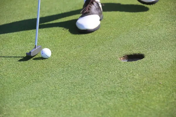A stock photo of a putter, ball and hole (not the 2016 putt)