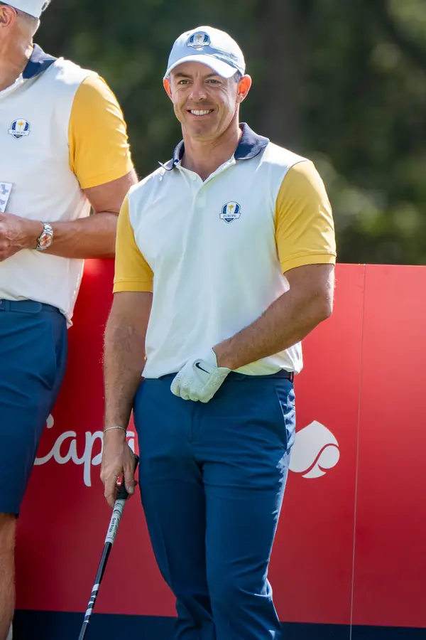 Rory McIlroy grinning on a tee at Ryder Cup practice, Bethpage, September 23, 2025 (not 2016)