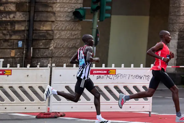 Sabastian Sawe (red vest) ahead of a pacemaker at the Berlin Marathon, September 21, 2025 (not the Seville half marathon; the pacer is not Kejelcha)