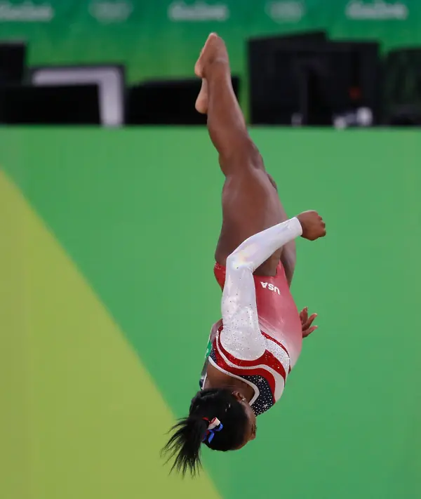 Simone Biles upside down in the air at the team final of the Rio 2016 Olympics, August 9, 2016 (not Tokyo)