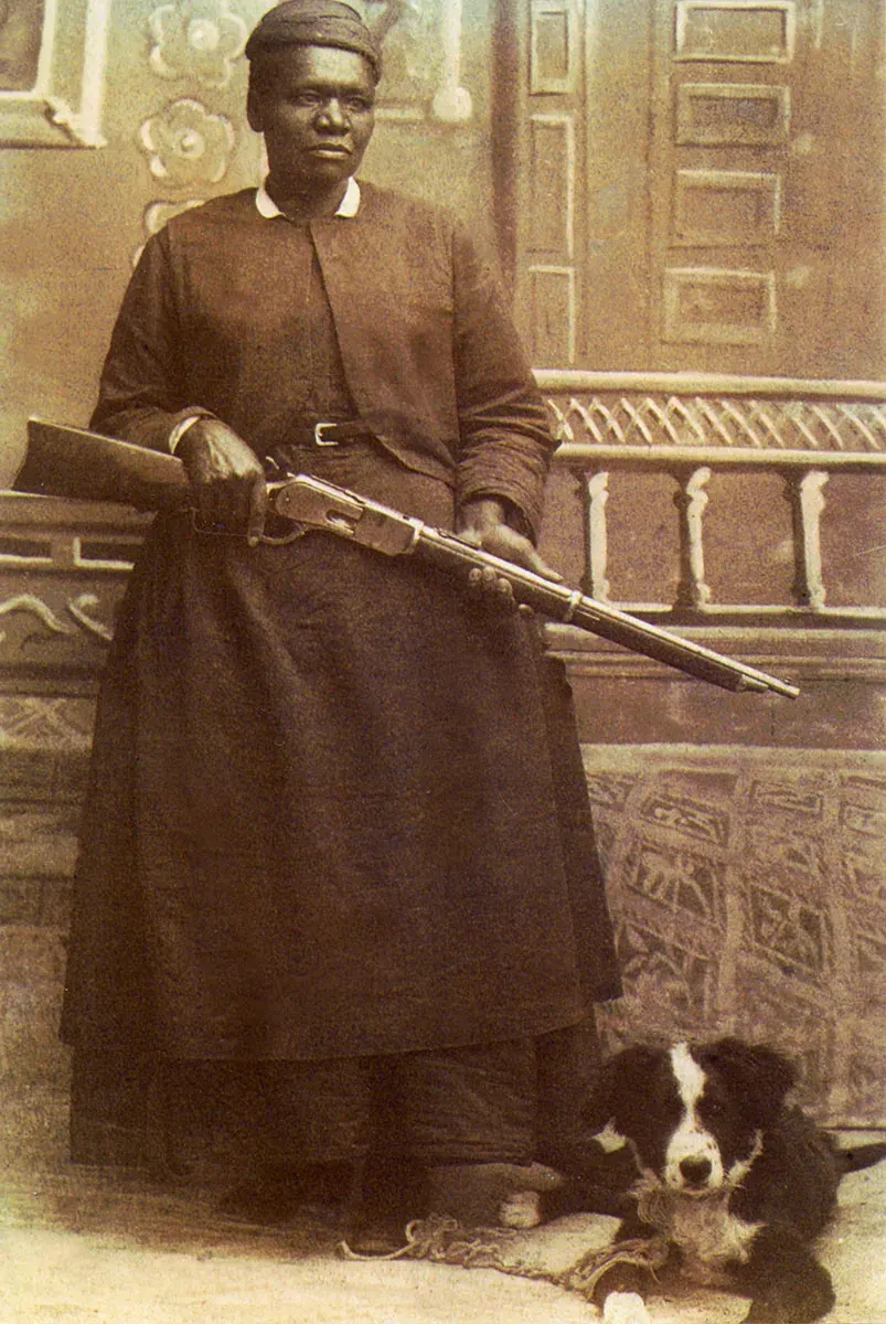 Mary Fields with a rifle and her dog, studio portrait, about 1895