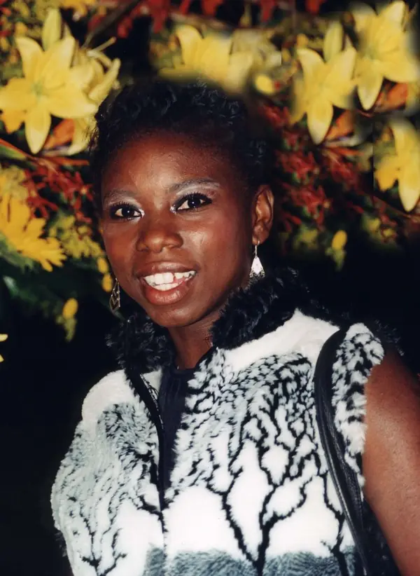 Surya Bonaly smiling in front of flowers, date unknown (not the 1998 Olympics)