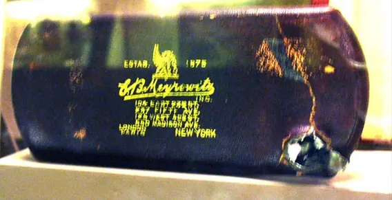 Roosevelt’s steel eyeglass case with the bullet damage, Theodore Roosevelt Birthplace National Historic Site, 2007 (cropped)