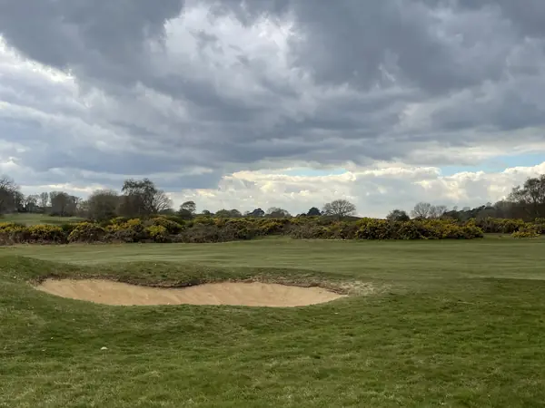 A fairway bunker under gray clouds, Aldeburgh Golf Club, Suffolk, England, April 13, 2022 (not Glen Abbey)